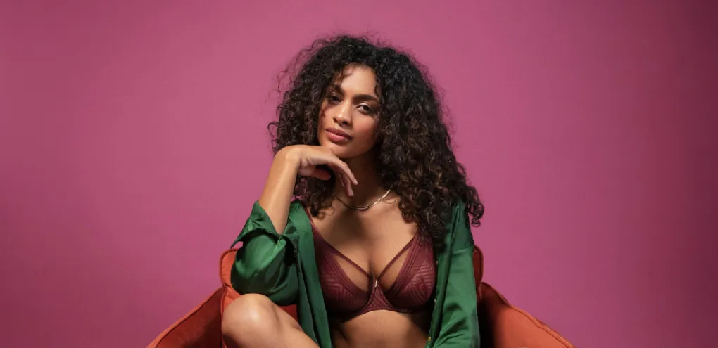 Woman in red chair wearing purple bra